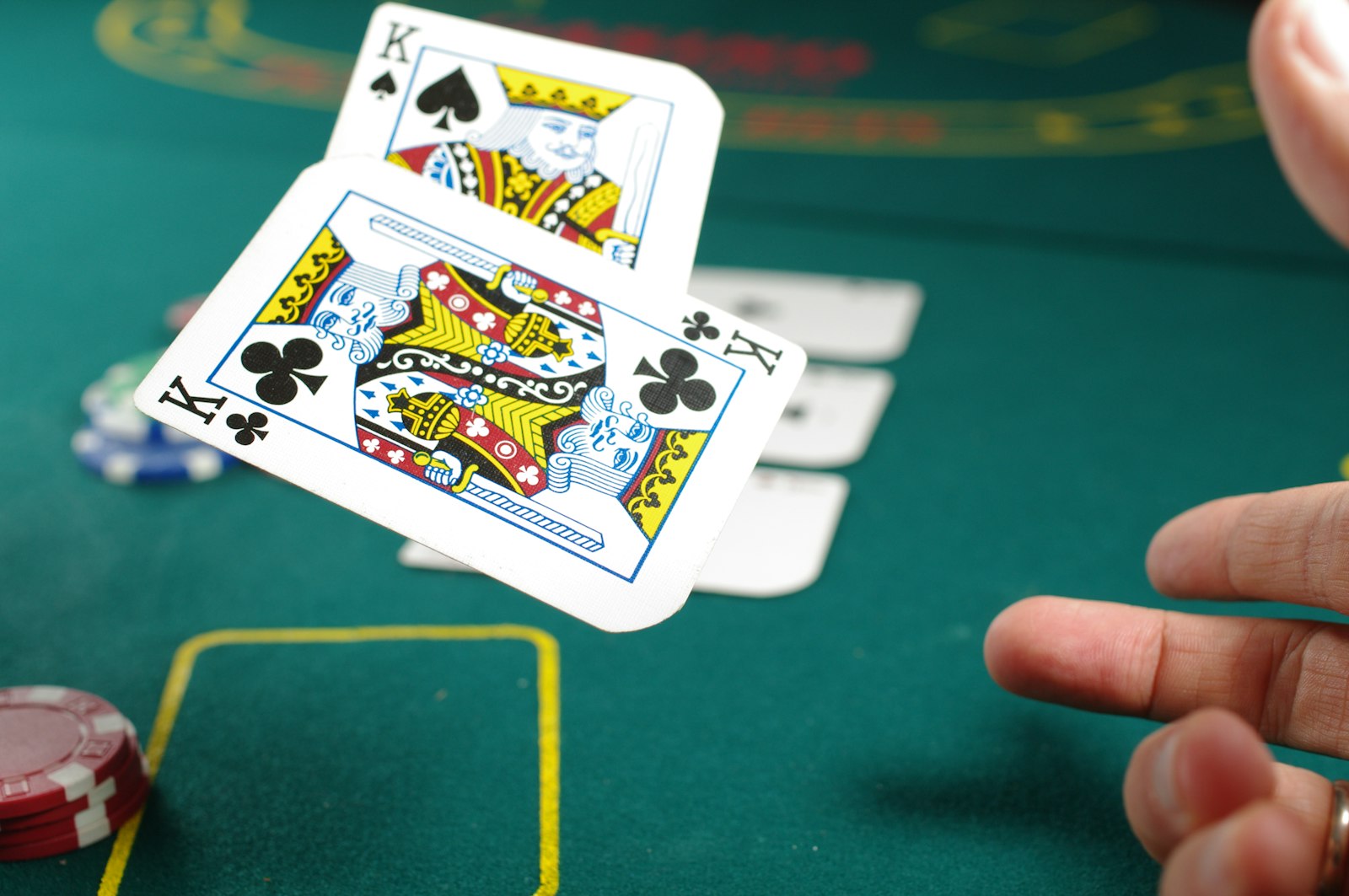 A player peeling up their hole cards at a poker table