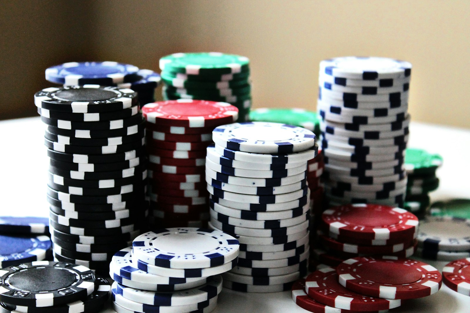 Tall stacks of poker chips in several colors on a table